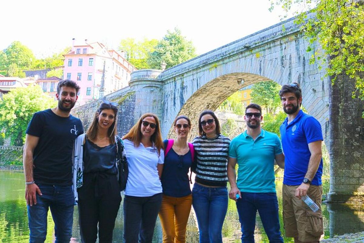 a group of people standing in front of a bridge