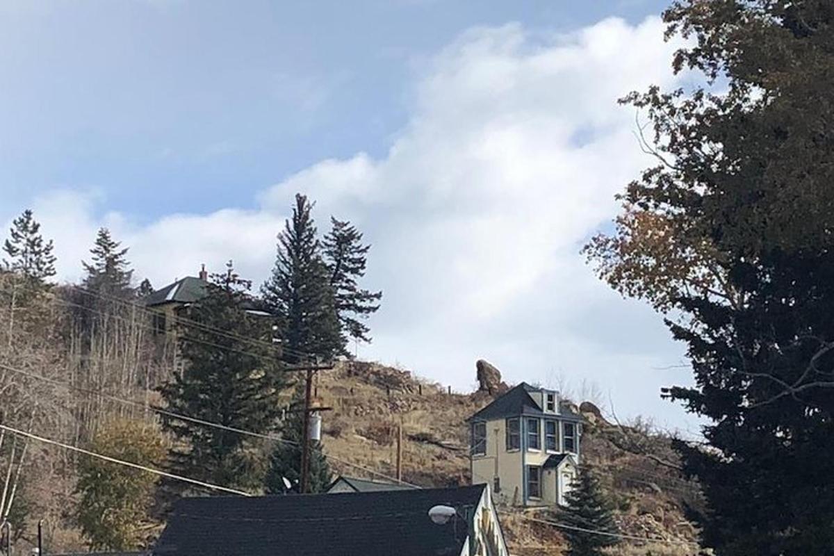 a house on the side of a hill with trees