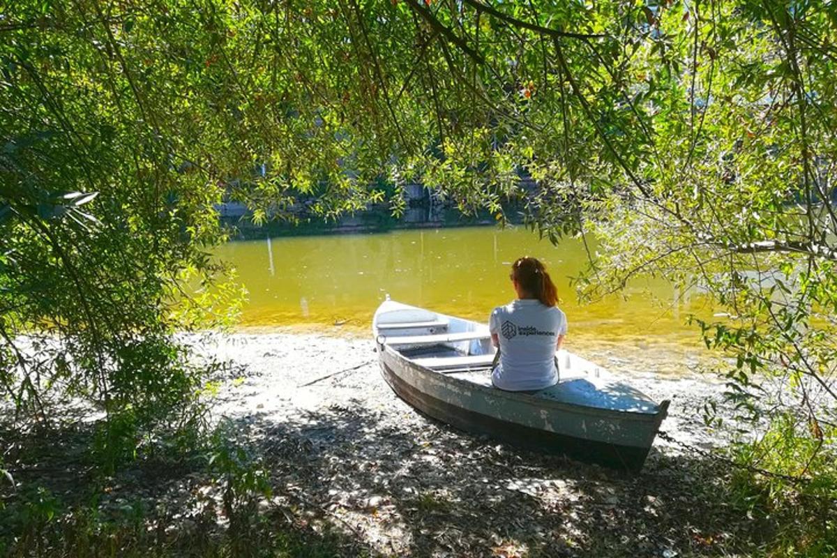 a woman sitting in a boat on a lake