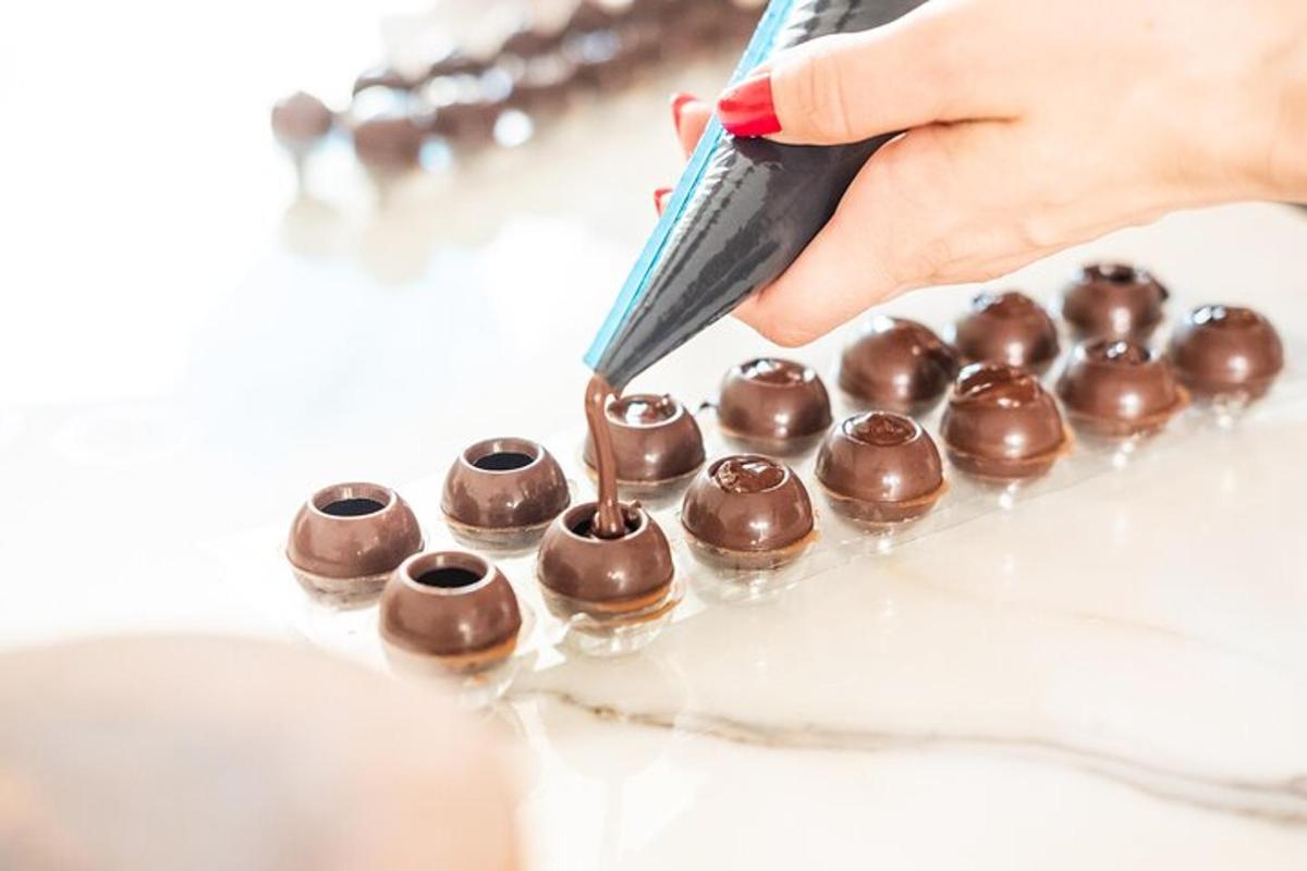 a person is picking up a chocolate ball from a wrapper