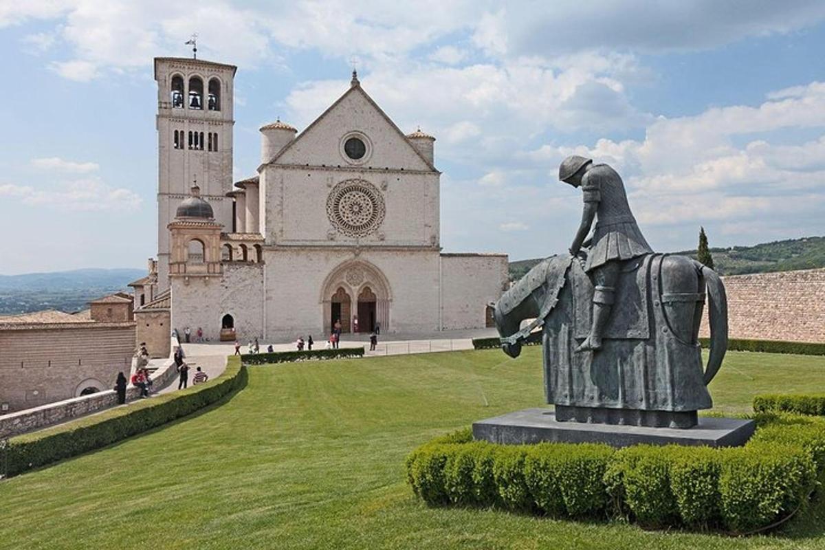 a statue in front of a building with a church