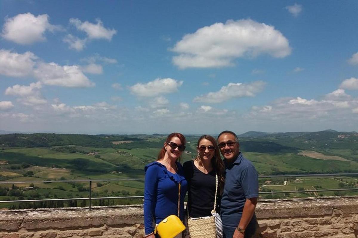 three people posing for a picture on top of a mountain