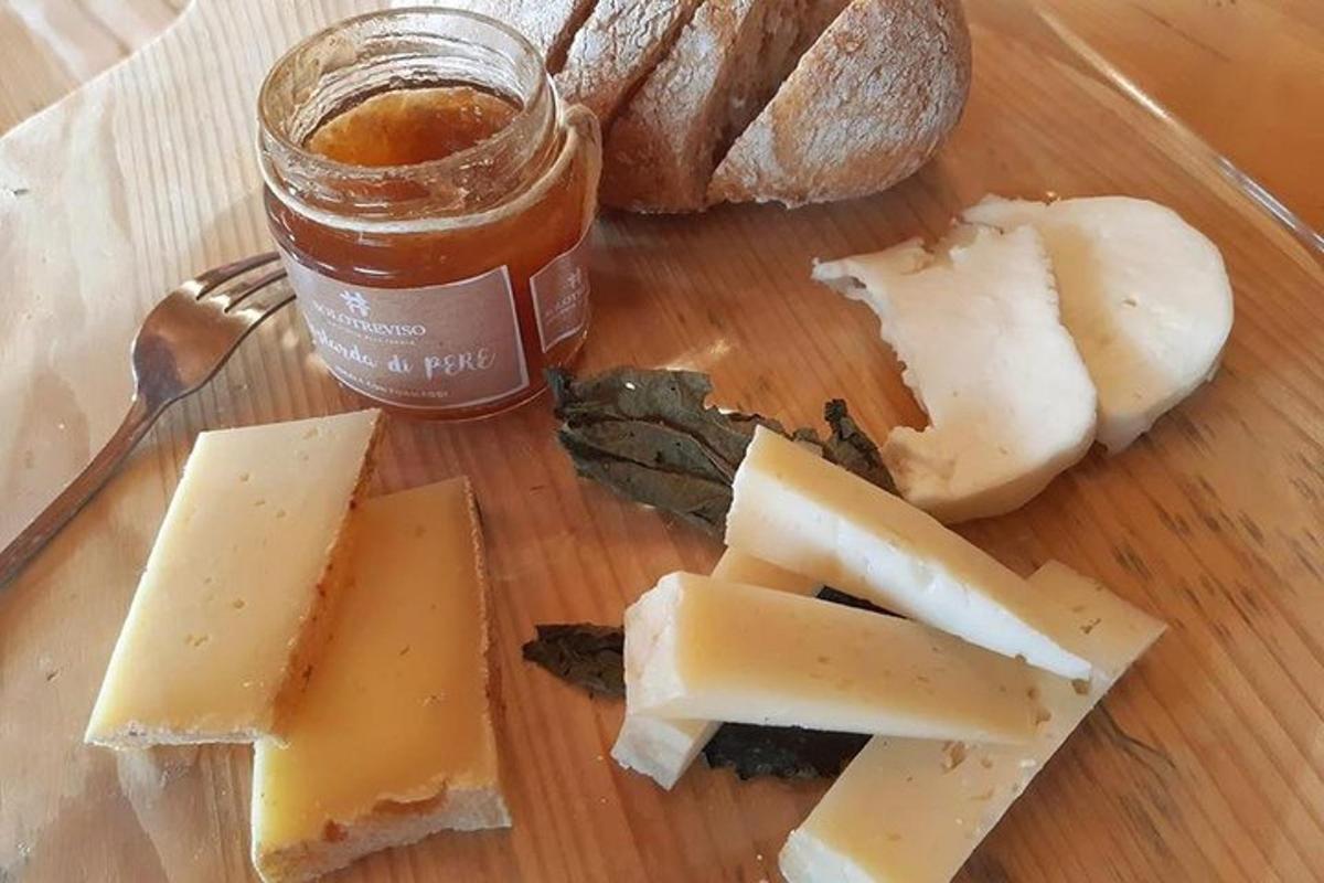 a plate with cheese and a jar of honey and bread