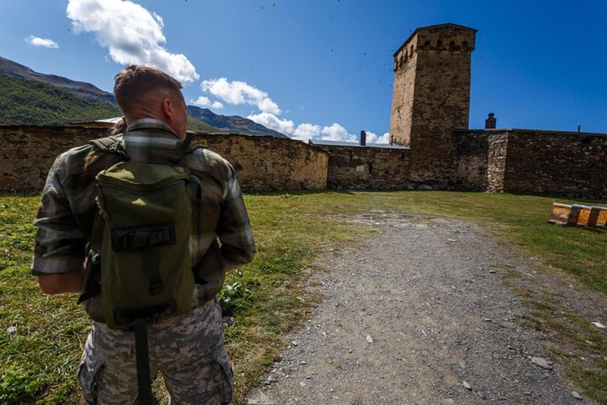 a man with a backpack standing in front of a building