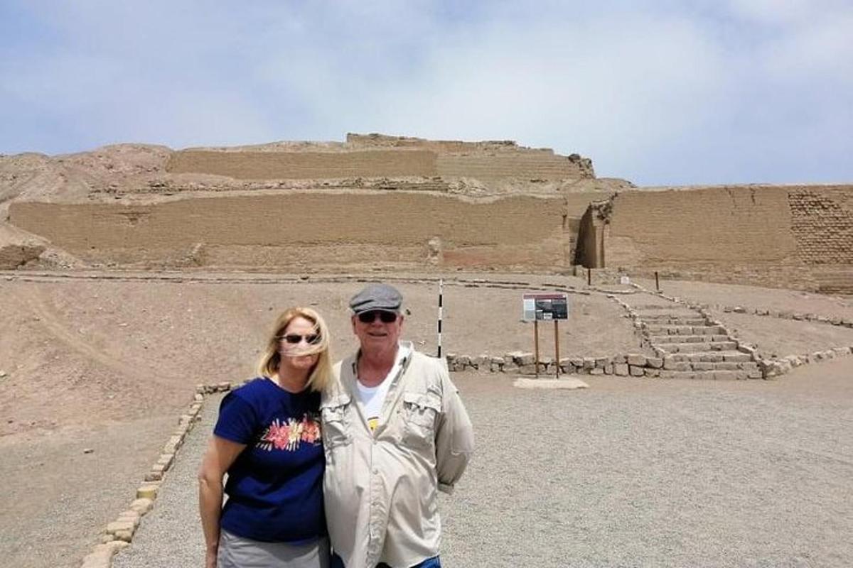 a man and a woman standing in front of a pyramid