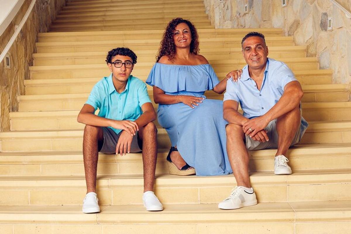 a group of three people sitting on the stairs