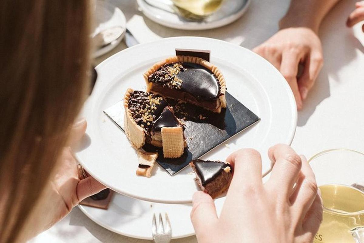 ženska, ki drži krožnik s kosom čokoladne torte