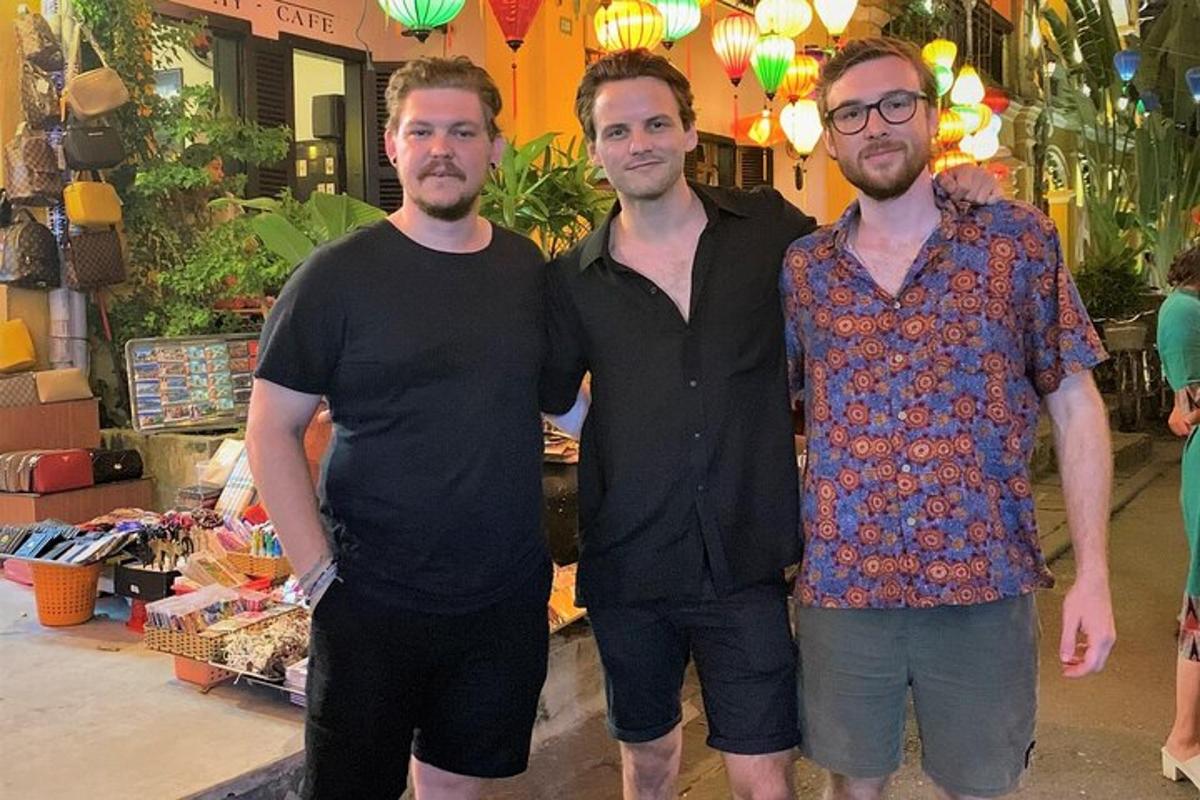 three men standing next to each other in a store