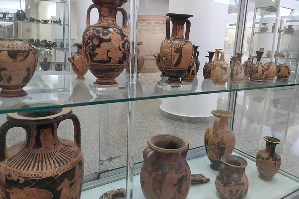 a group of vases on display in a glass case