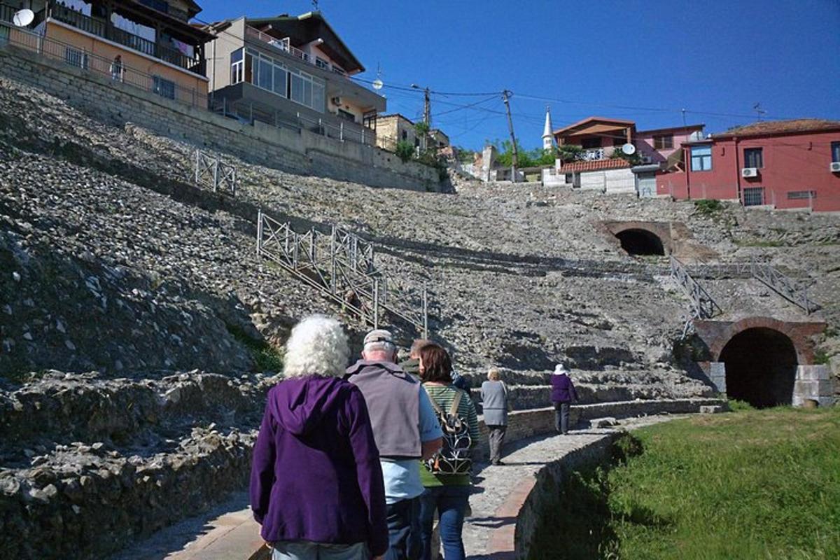 a group of people walking down a stone path