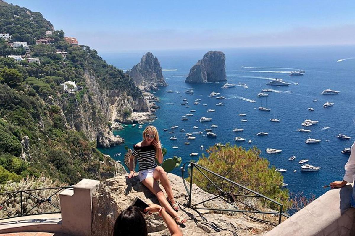 una donna seduta su una roccia che guarda l'oceano