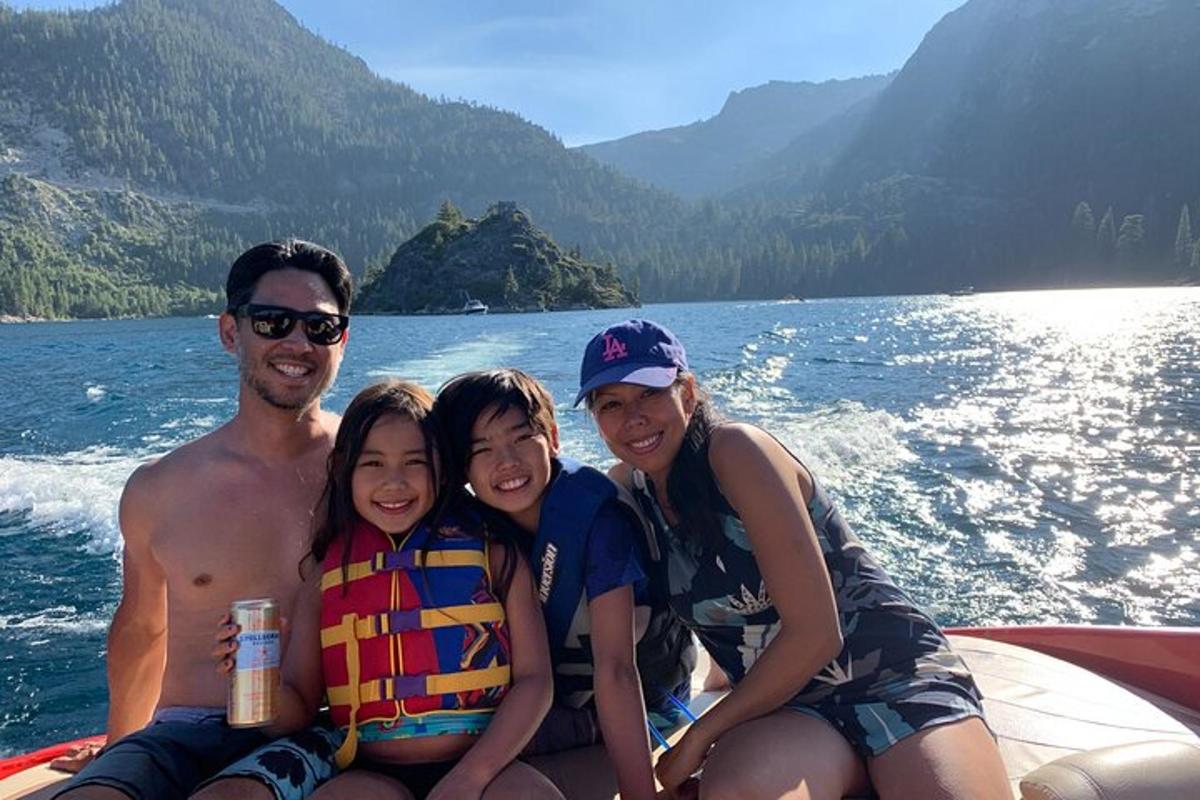 a group of people sitting on the back of a boat