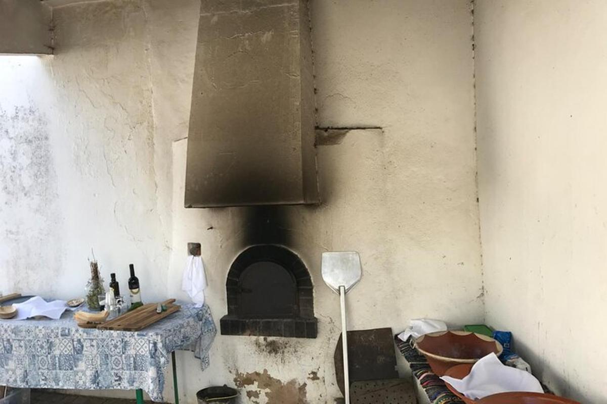 a kitchen with an oven with a table with bottles