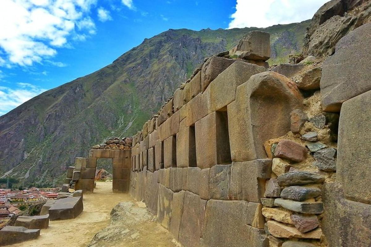 a stone wall with a mountain in the background