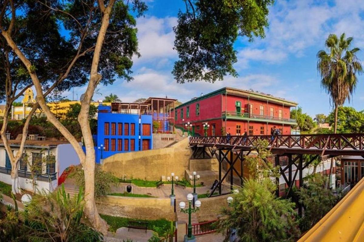 a bridge over a city with a red building
