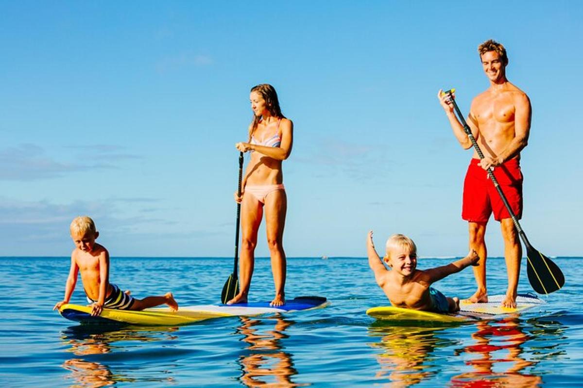 a group of people standing on surfboards in the water