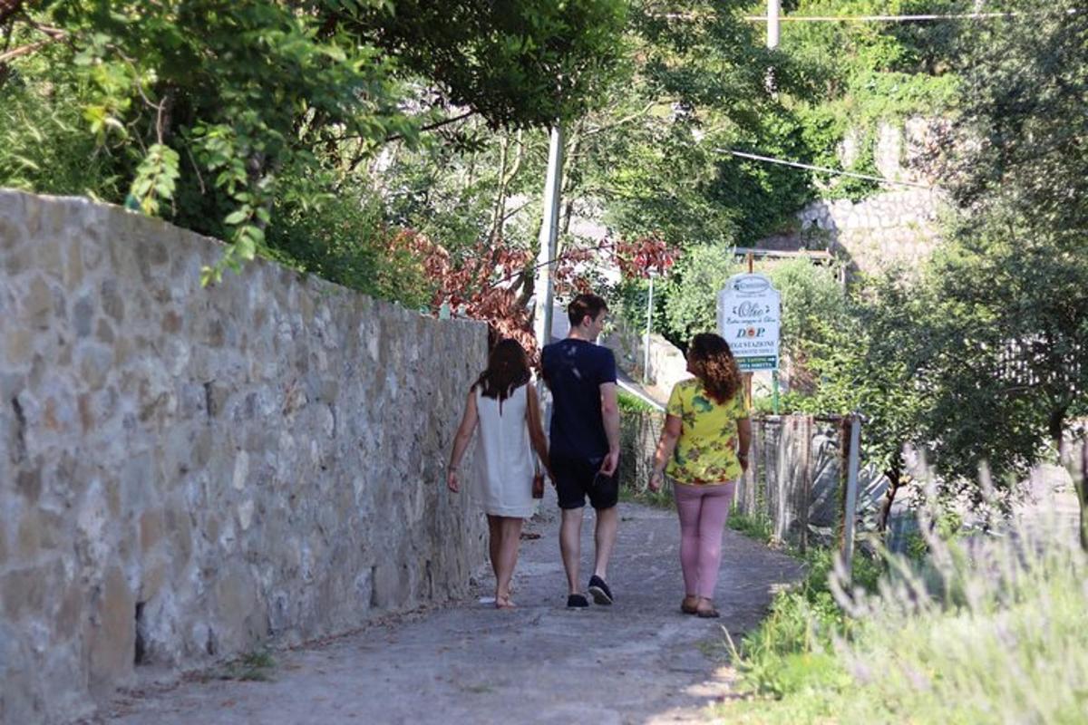 a group of people walking along a stone wall