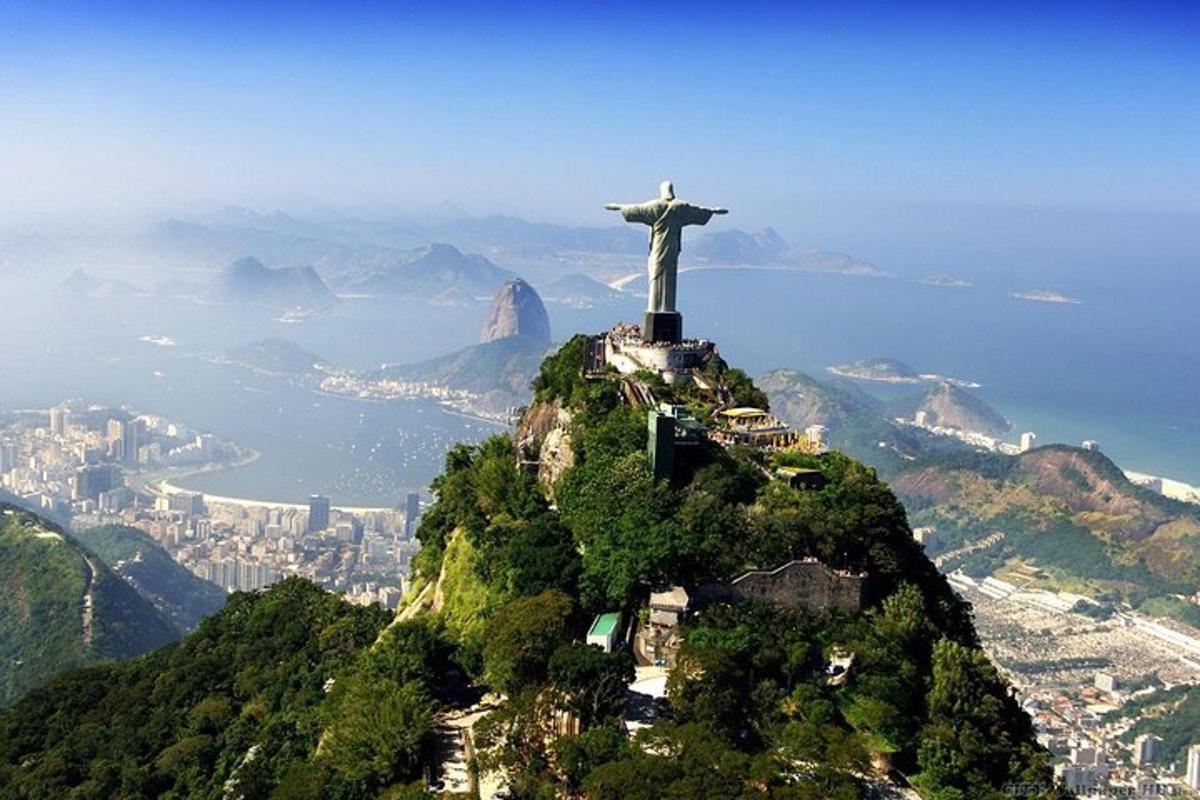 a statue of christ the redeemer on top of a mountain