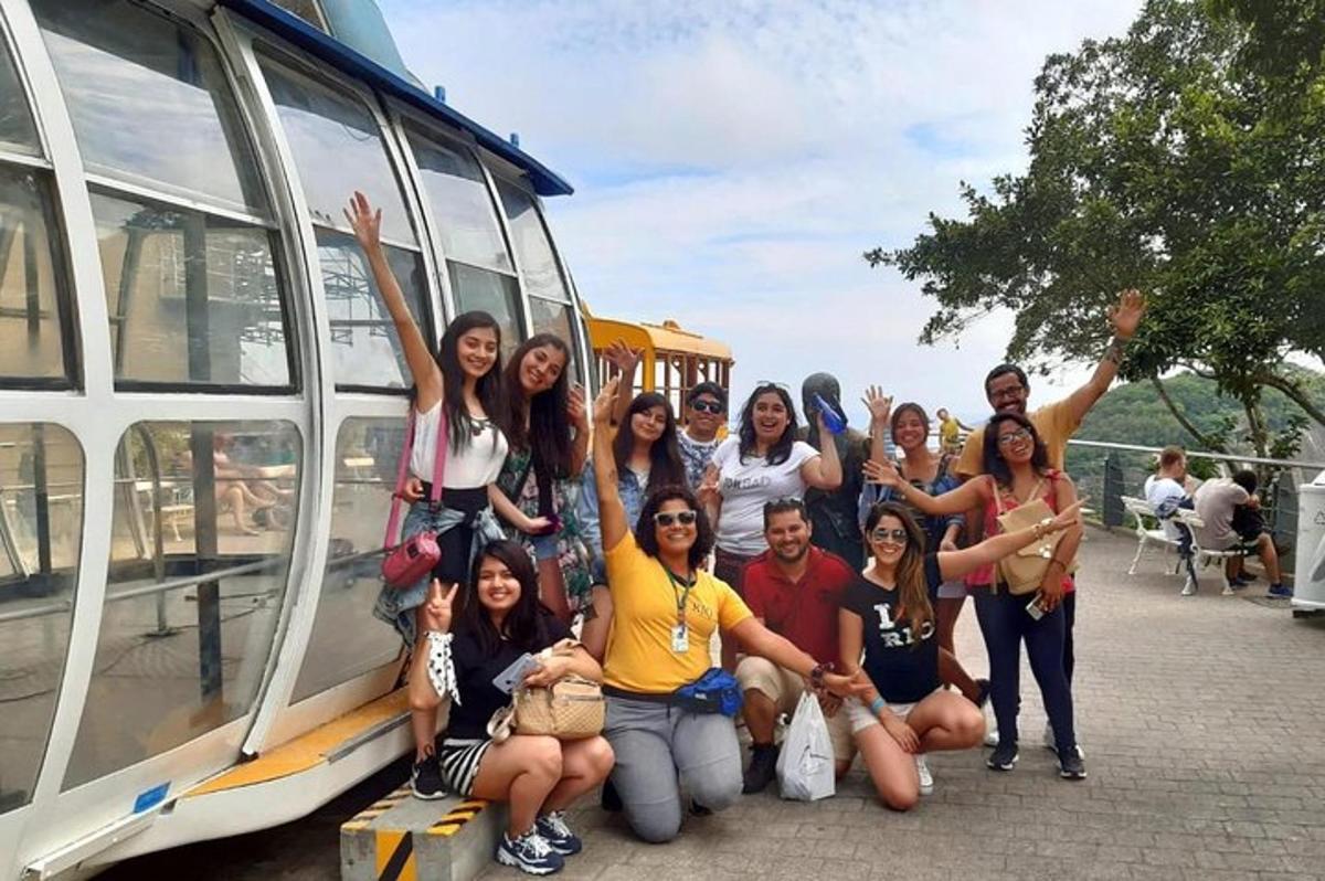a group of people standing next to a bus