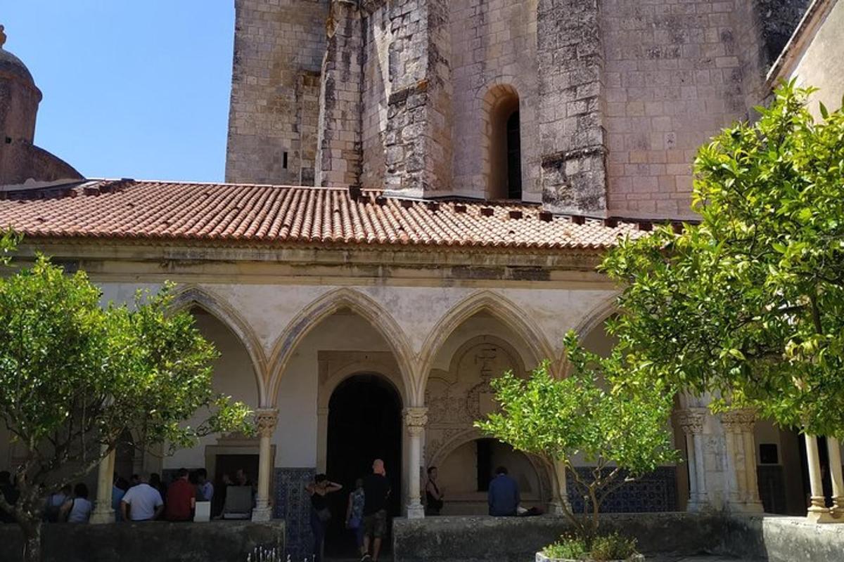 an old building with people standing outside of it