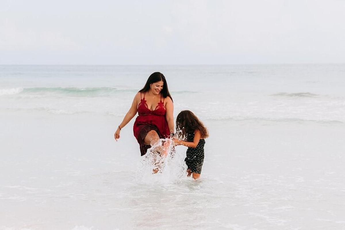 a woman is playing with a child in the ocean