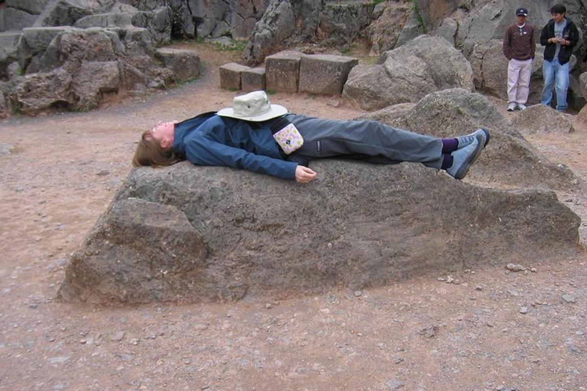 a person laying on top of a large rock