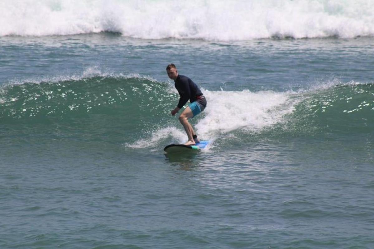 a man riding a wave on a surfboard in the ocean