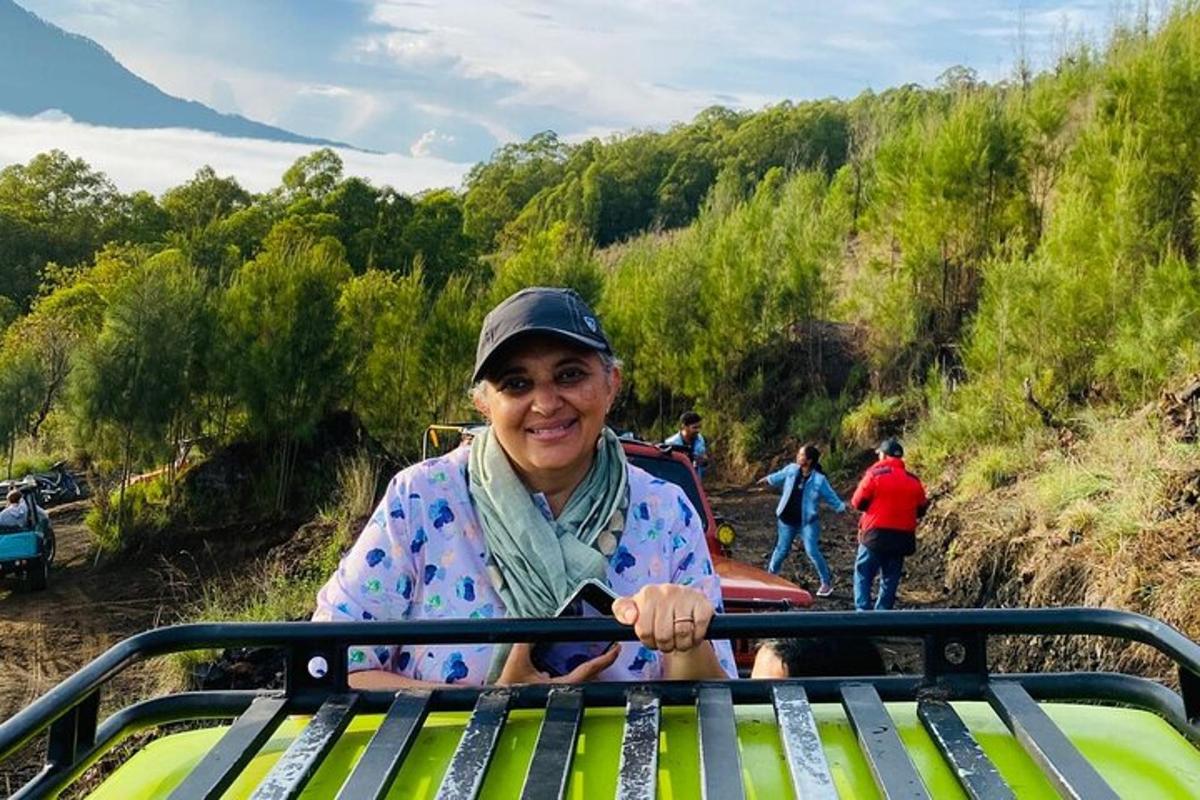 a woman sitting on a bench on a hill