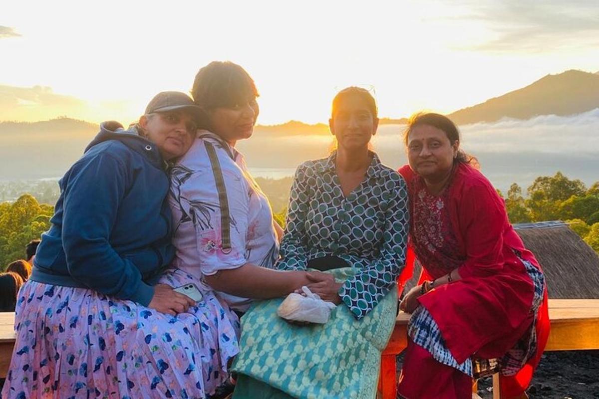 a group of women posing for a picture on a mountain