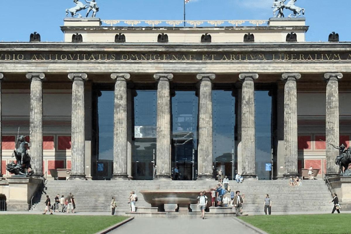 a large building with people walking in front of it