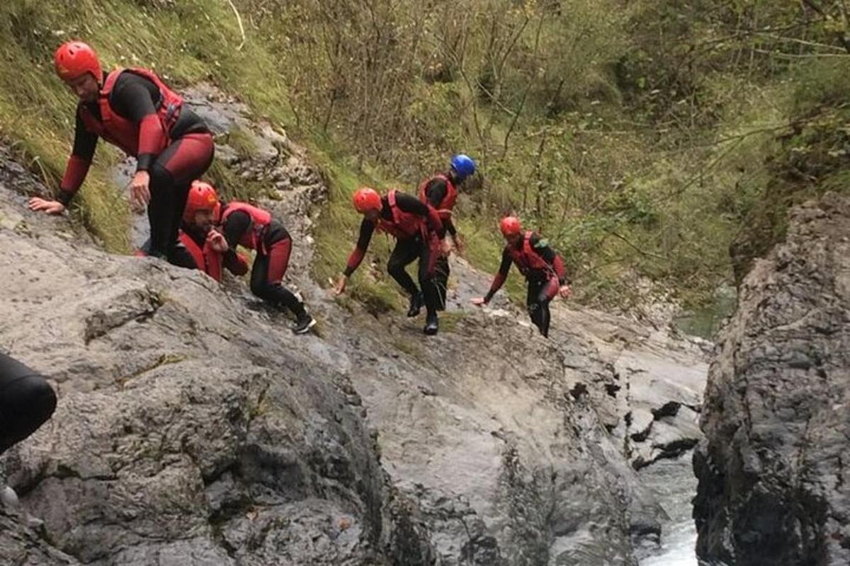 skupina lidí stoupající na skalnatou horu