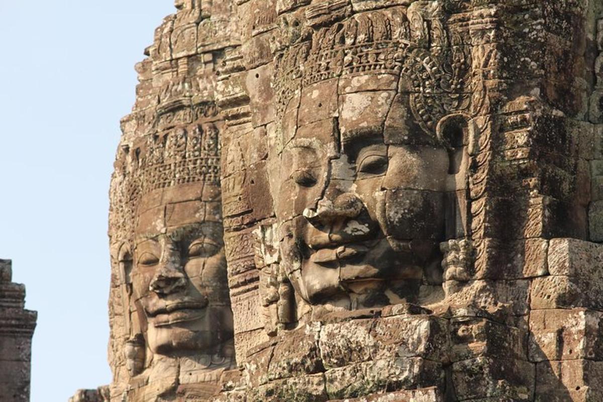 a stone wall with two faces on it