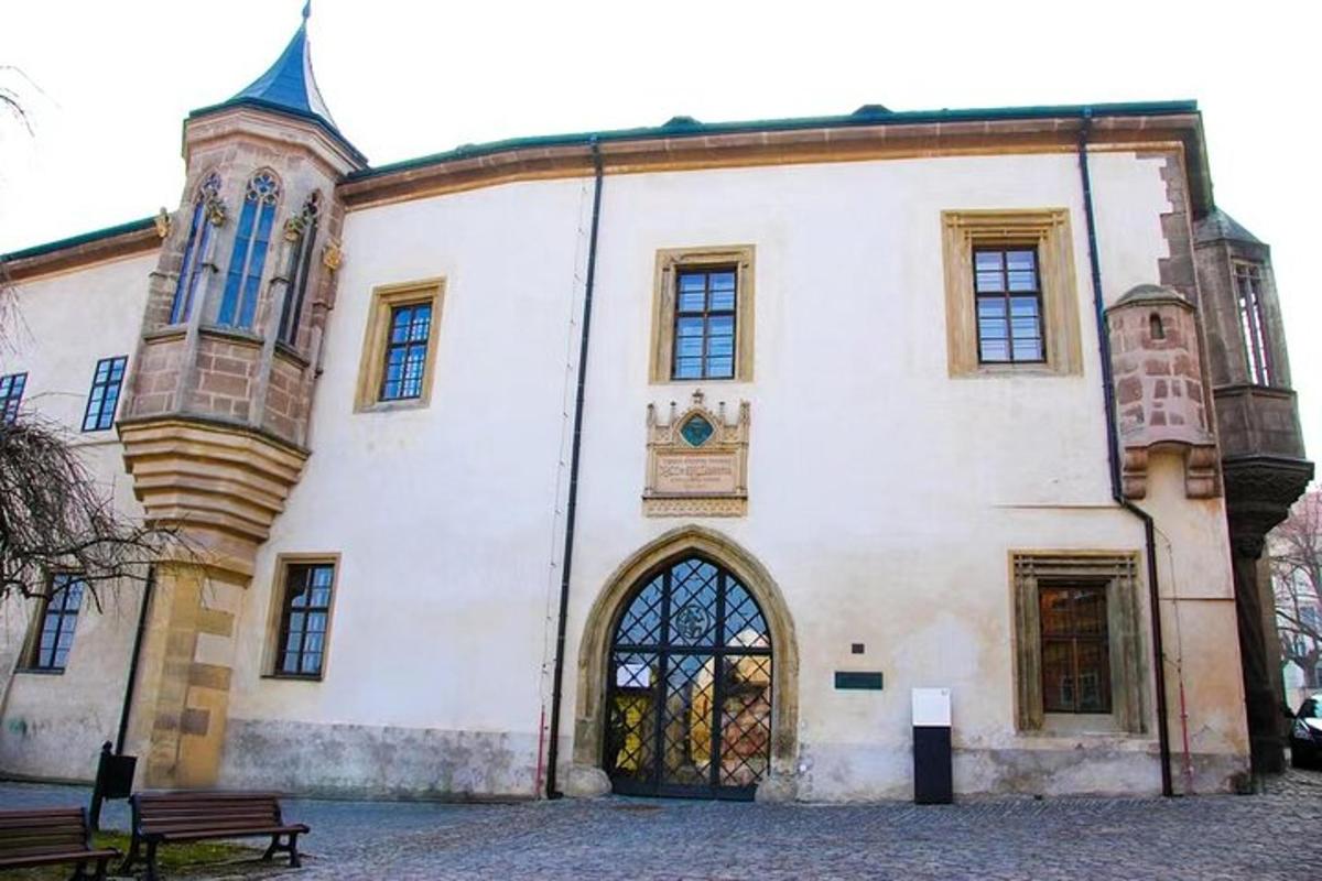 a large white building with a bench in front of it