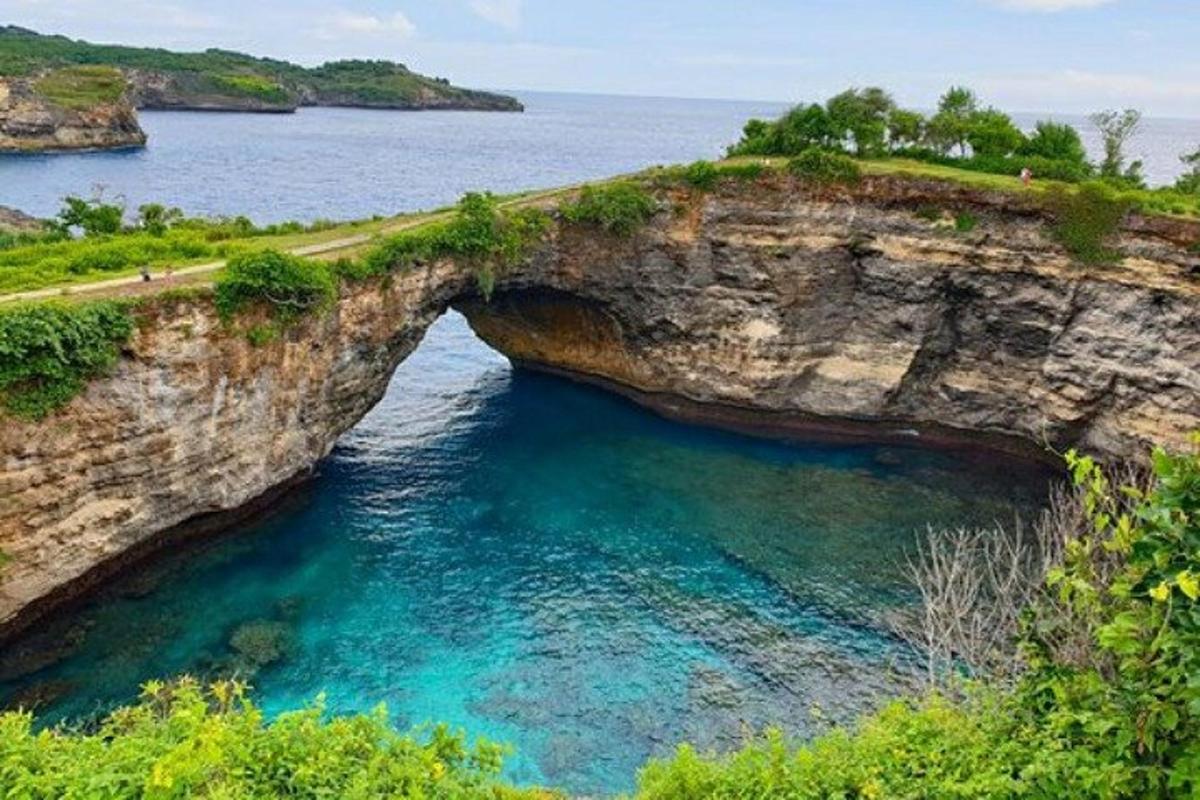 an arch in a rock formation in the water