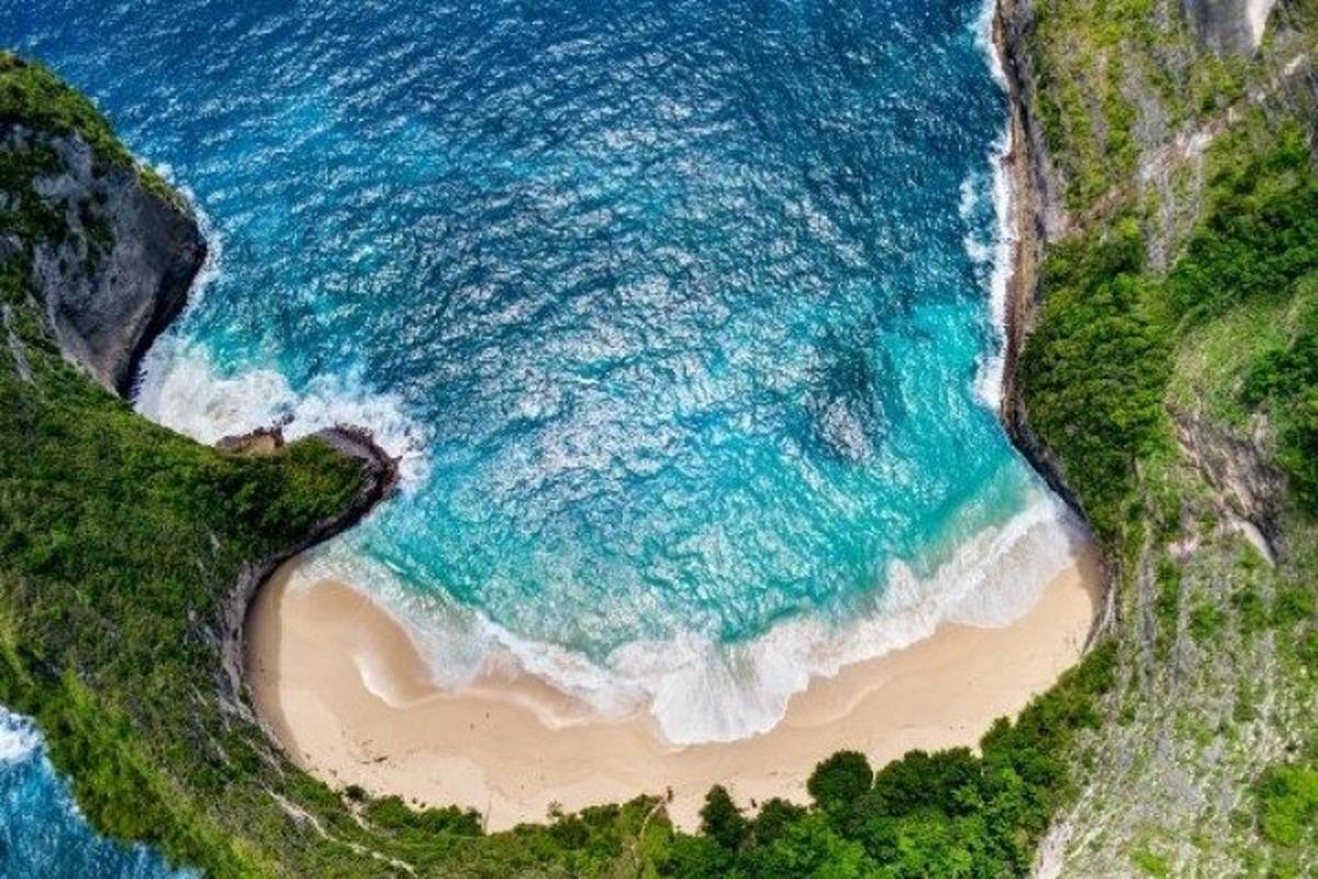 an overhead view of a beach and the ocean