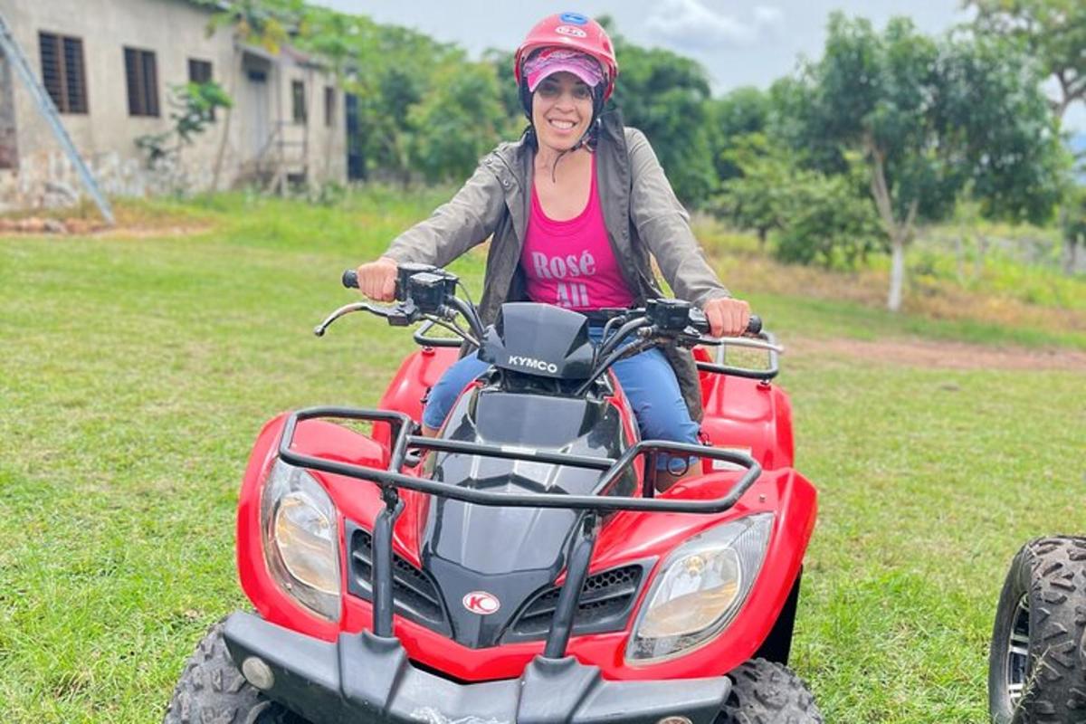 a woman riding on a four wheeler in a yard