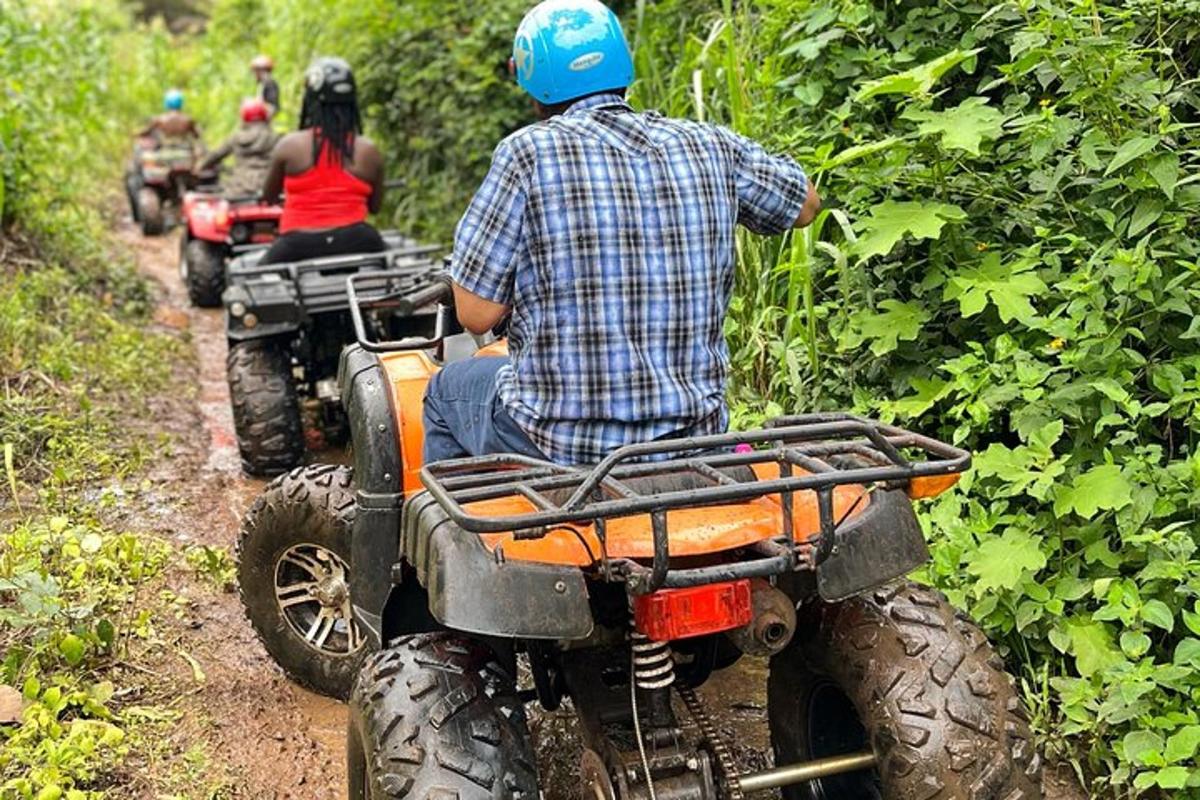 a man riding on a four wheeler on a trail