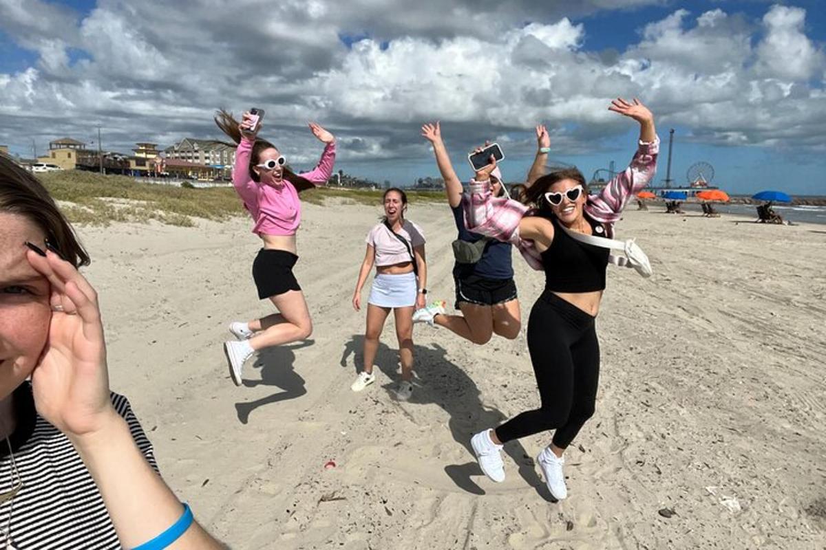 a group of women jumping on the beach
