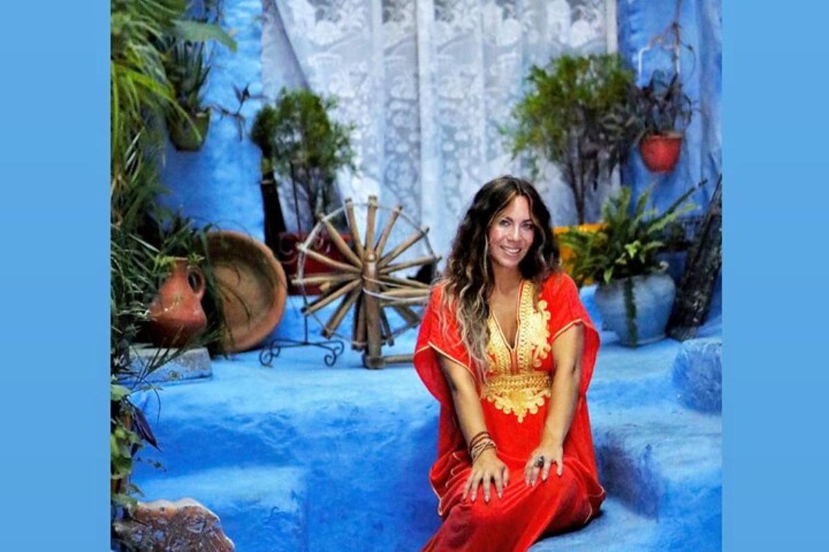 a woman in a red dress sitting on the ground