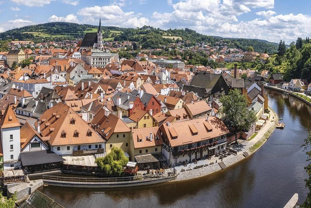 an aerial view of a town next to a river