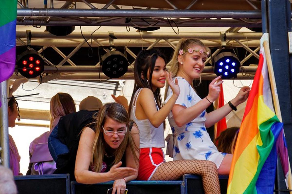 tre ragazze sedute su un autobus con le bandiere