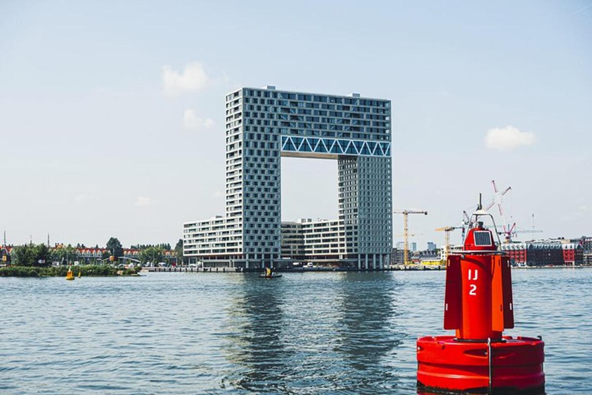 a red object in the water in front of a building