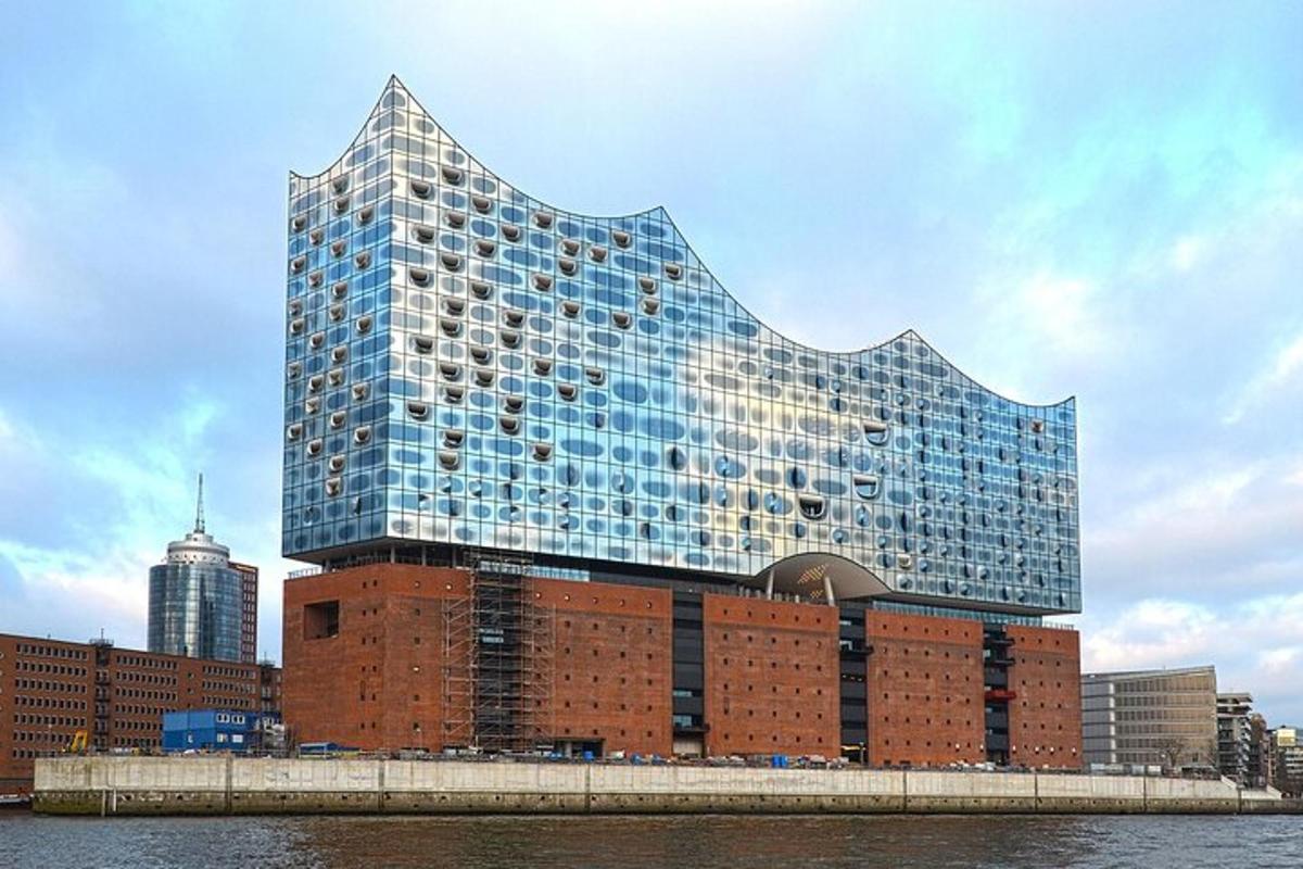 a tall glass building on top of a brick building
