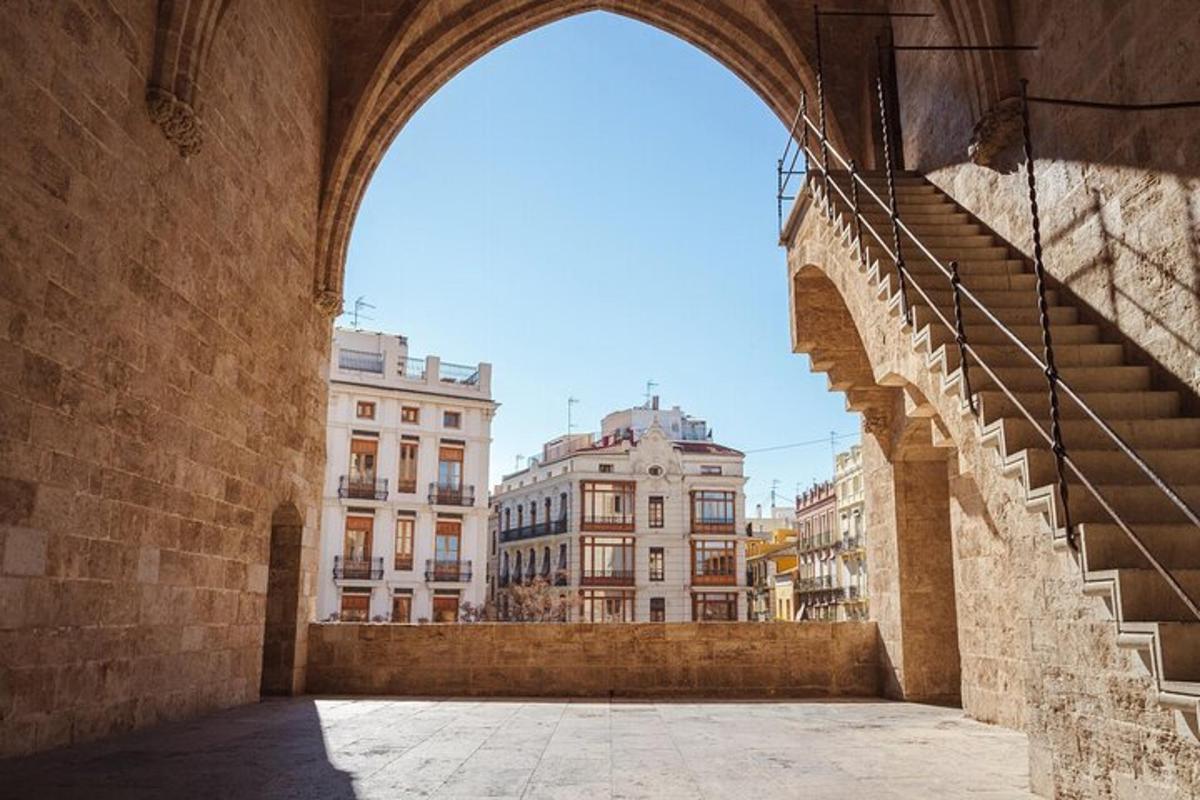 an archway in a city with buildings in the background