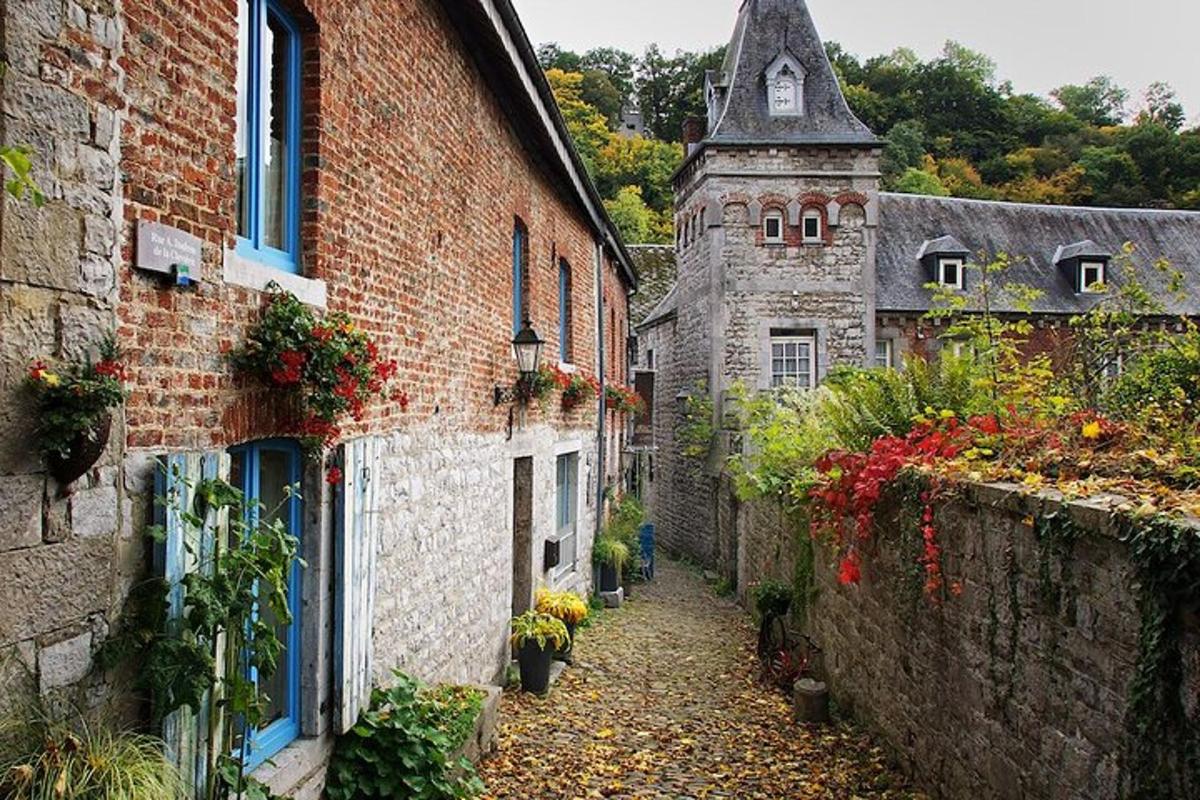 un vicolo in un vecchio edificio in pietra con fiori sopra