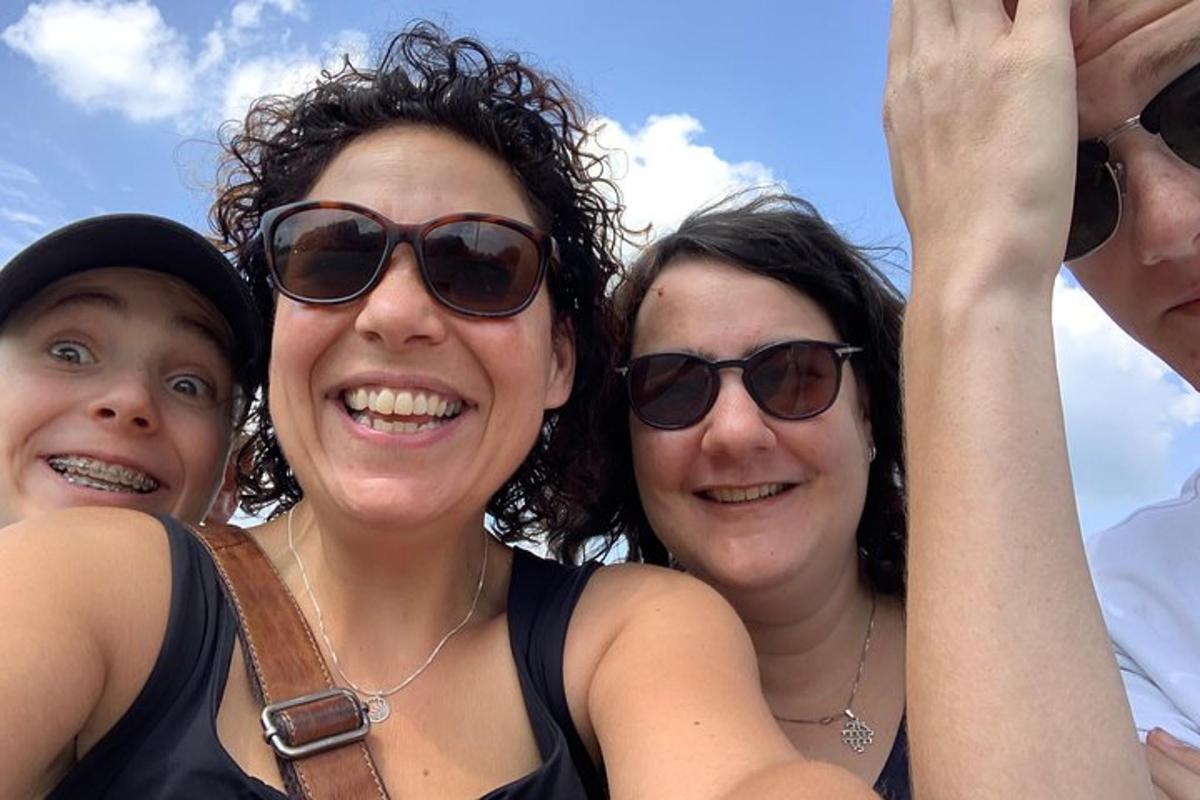 three women wearing sunglasses posing for a picture
