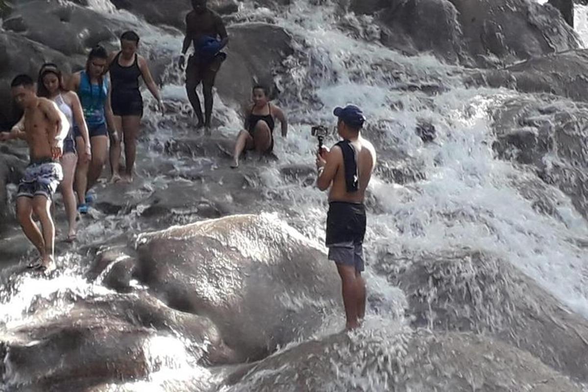 a group of people standing on rocks in the water