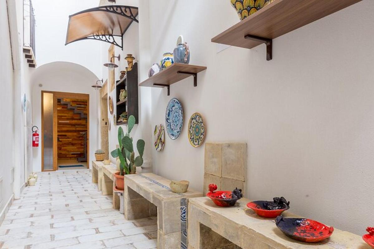 a hallway with bowls on the wall of a house