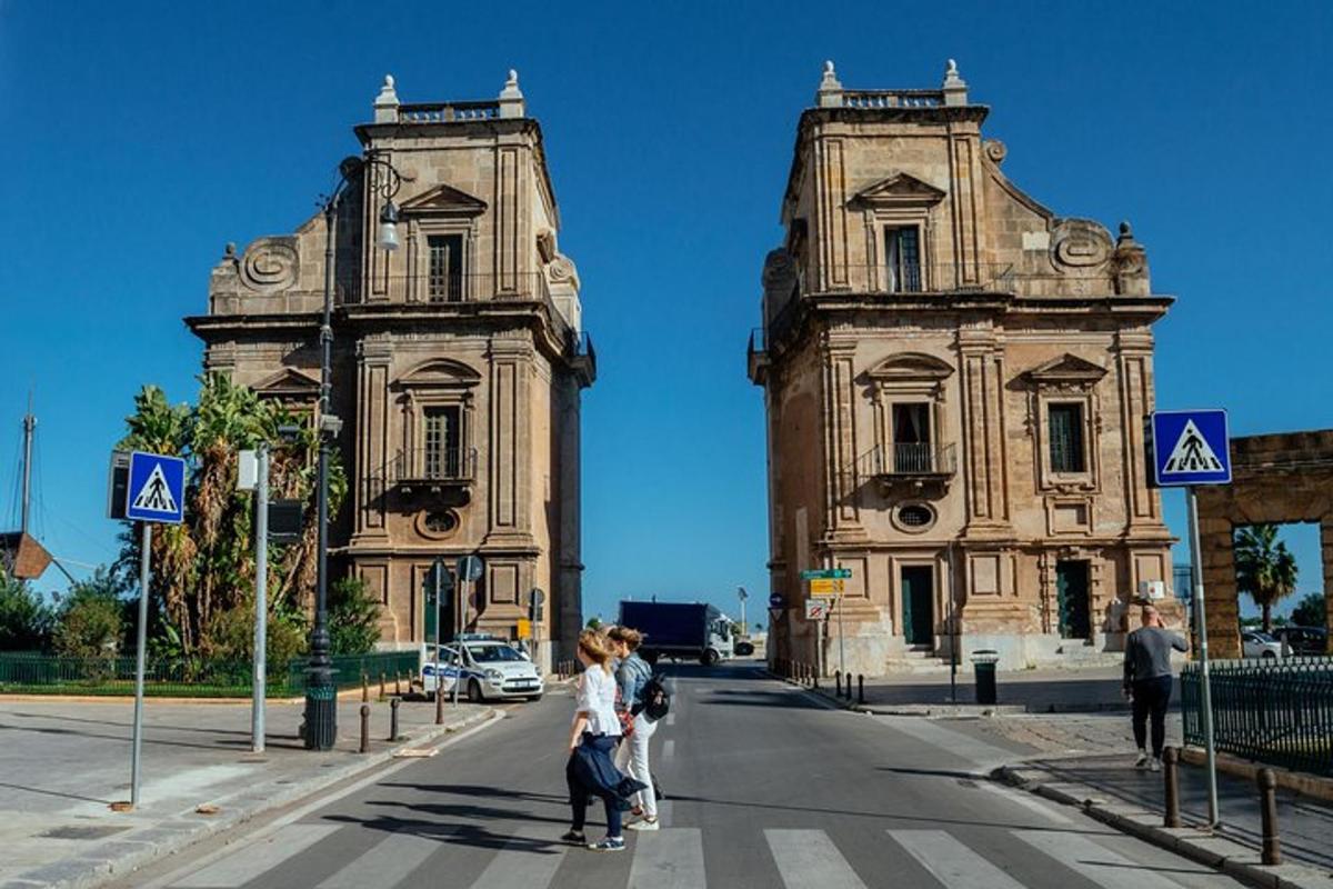 a group of people crossing a street in front of a building