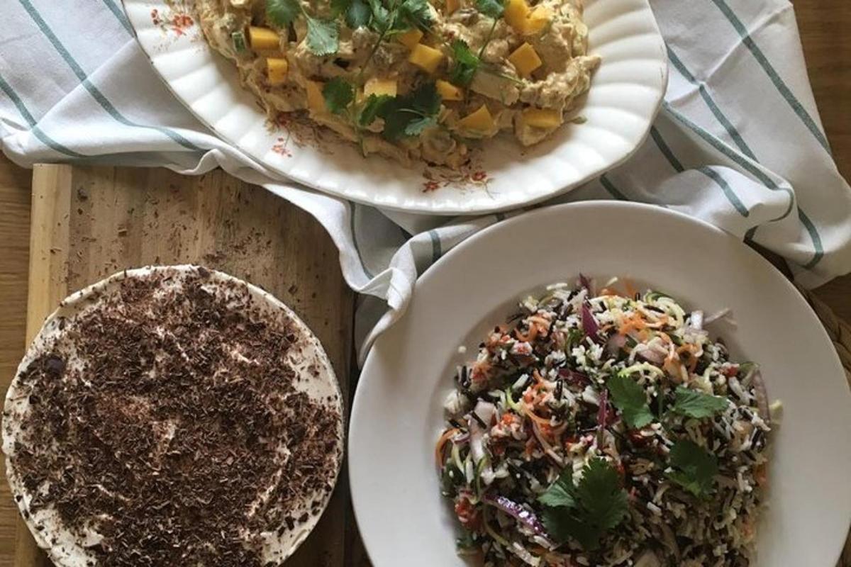 two plates of food and a bowl of salad on a table